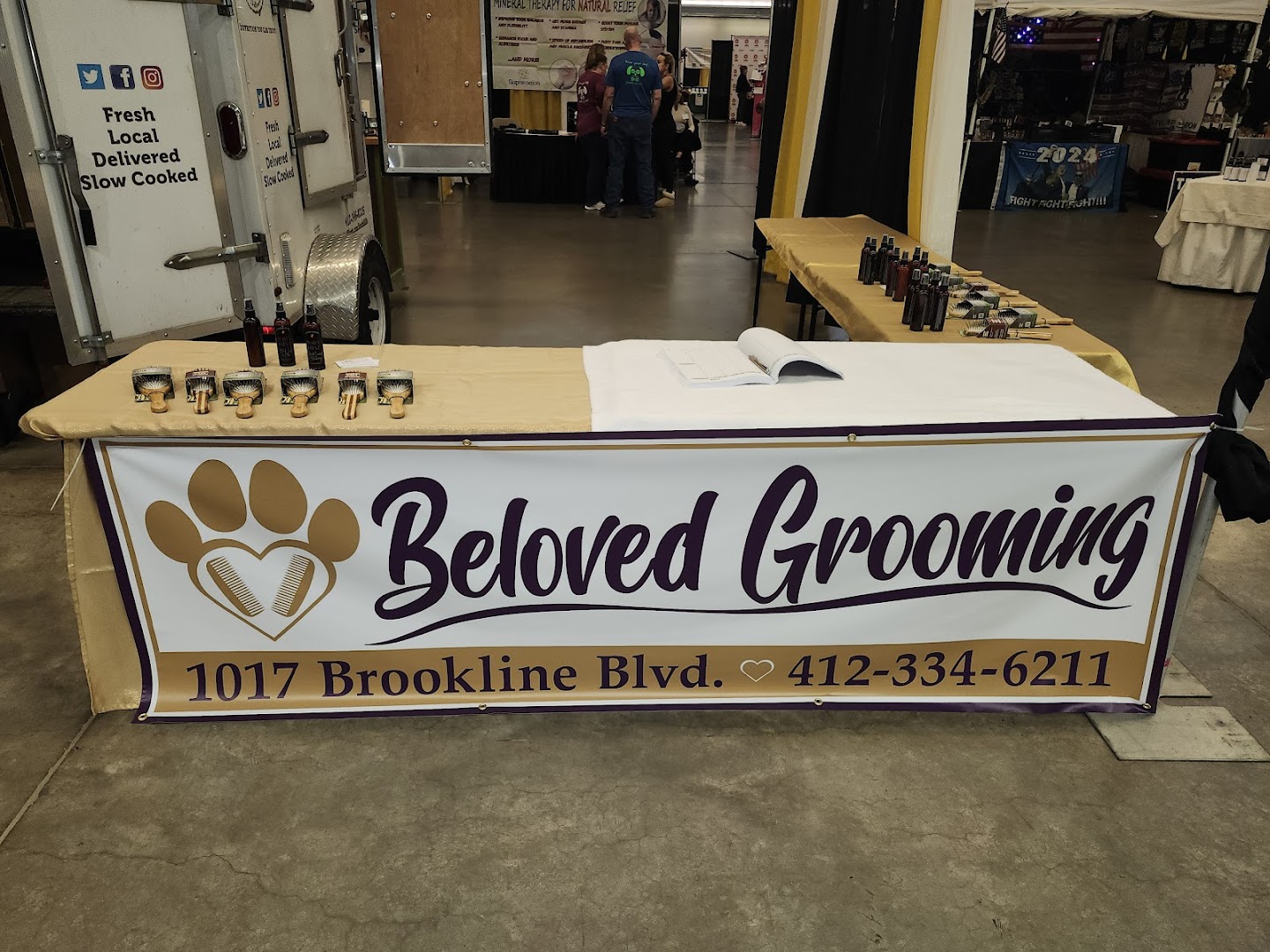 Beloved Grooming promotional banner at a local event